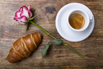 coffee, croissant and rose for romantic breakfast