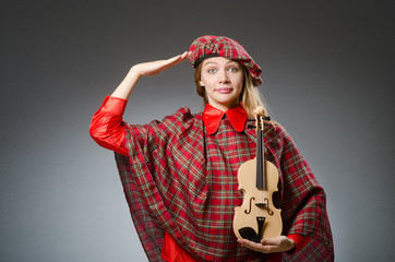 Woman in scottish clothing in musical concept