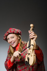 Woman in scottish clothing in musical concept