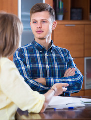 Spouses with documents for bank at home.