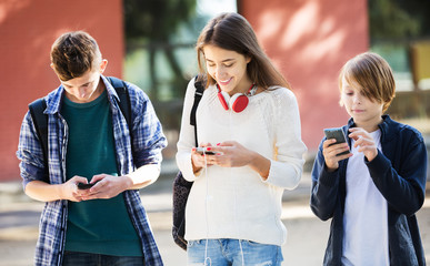 Teenagers with mobile phones