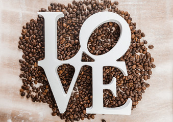 Coffee beans and wooden letters with the word love.