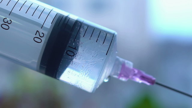 Close-up shot of syringe during injection, drug addiction problem, aids epidemic