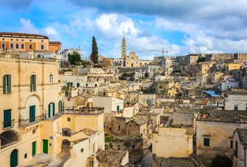 Fototapeta na wymiar Ancient town of Matera (Sassi di Matera), European Capital of Culture 2019, in beautiful golden morning light with blue sky and clouds, Basilicata, southern Italy