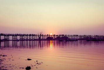 Fototapeta na wymiar Beautiful sunset with silhouette U- Bein bridge at lake Amarapura, Mandalay, Myanmar