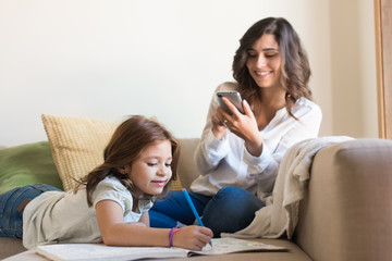 Girl painting with her mom chating