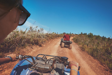 Young people driving quad bikes