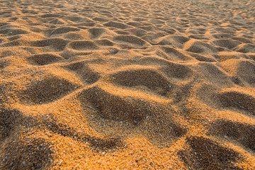 Beach sand with golden light on surface sand