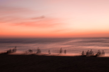 Blur people relax on tropical sunset beach abstract background.
