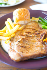 Grilled pork steak with black pepper,French Fries,garlic bread