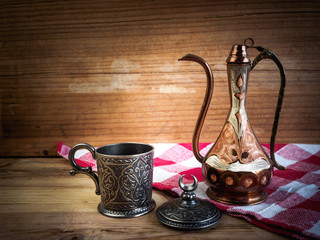 Turkish teapot with arabic decoration with metal cup and dish