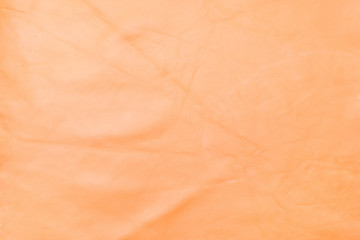 Close up orange color crumpled leather texture background