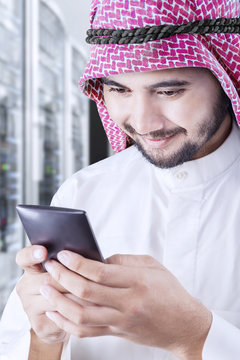 Arabic entrepreneur messaging on mobile phone