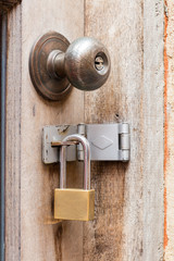 Rusty old door knob and padlocks