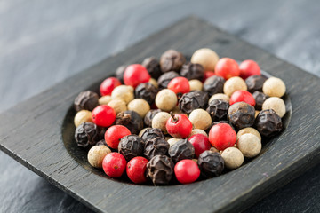 Colorful peppercorn in wooden bowl