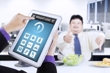 Weight loss app and overweight businessman
