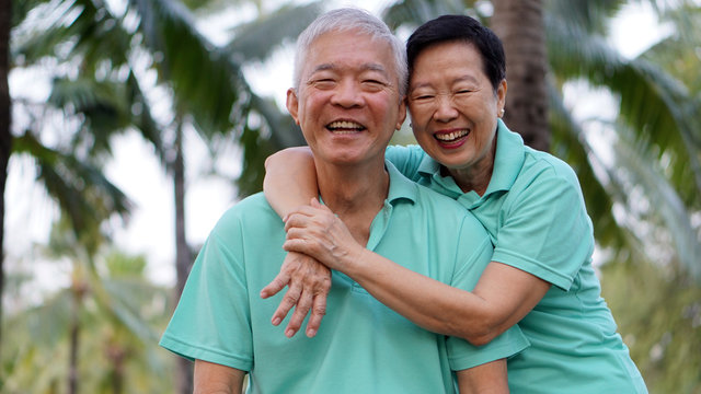 close up potrait of Asian senior couple on bright green backgrou