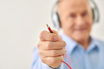 Grandpa keeps cord from headset