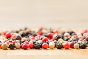 Colorful peppercorn on wooden background