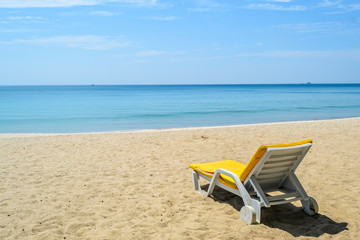 Fototapeta na wymiar Yellow Beach chairs on White Sand Beach with blue sky in Phuket,Thailand