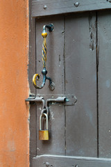 Rusty old door handle and padlocks