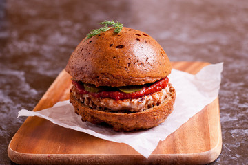 Sandwich with chicken burger, tomate souce and pickled cucumber