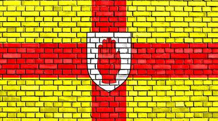 flag of Ulster painted on brick wall