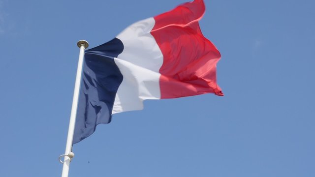 Close-up of French flag in front blue sky slow waving on wind 1080p FullHD slow-mo footage - Flag of France and blue sky slow motion 1920X1080 HD video 