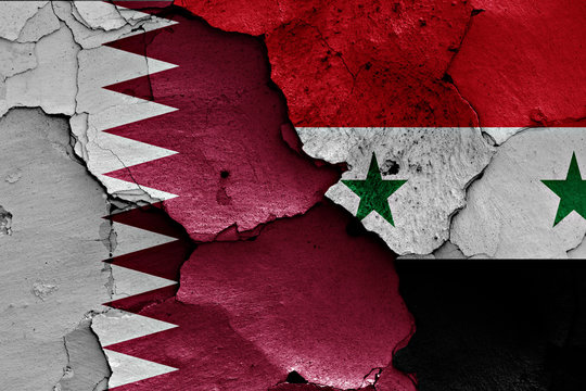 flags of Qatar and Syria painted on cracked wall