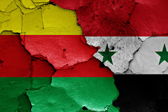 flags of Syrian Kurdistan and Syria painted on cracked wall