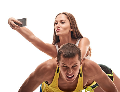 man doing push ups and woman fun with selfie