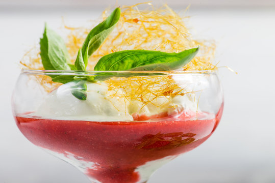 closeup of ice cream with fresh strawberries and mint in winegla