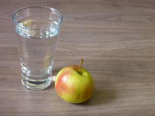 apple and a glass of pure water