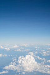 Naklejka na ściany i meble Clouds in blue sky, aerial view from airplane window.