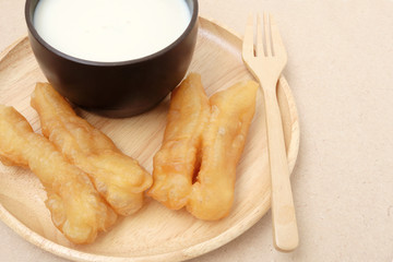 soybean milk and fried doughstick on wood plate