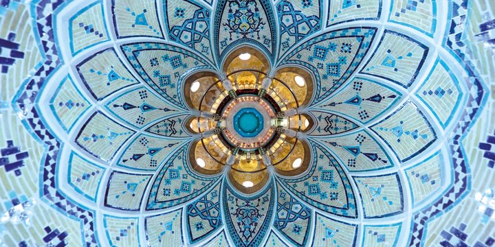 Beautiful mathematical geometric turquoise colored decoration of the brick ceiling and walls at a traditional Middle East bath house in Kashan, central Iran - wide angle view