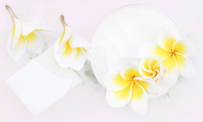 Fototapeta na wymiar Top view of organic cream and soap bar with frangipani flower