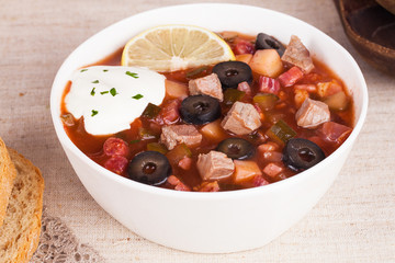 thistle soup with meat sour cream and lemon in a still life
