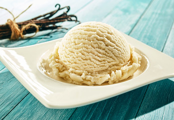 Scoop of creamy vanilla ice cream on a plate