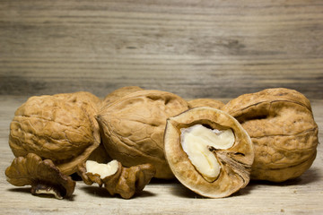 Walnut in shell on wooden background
