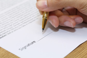 businessman hand signing a contract paper