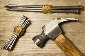 The hammer and nails on wooden background