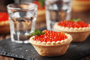 Traditional russian red caviare on the wooden table