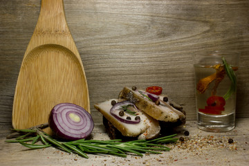 Slices of bacon with spices with rye bread. Kraft paper as the background.