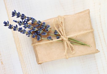 Handmade simple cute gift wrapping. Gift box in parchment paper and dried lavender twig decor.