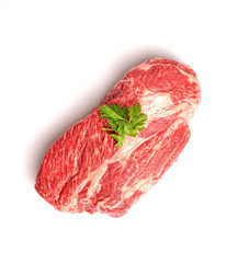 marble veal steak with parsley on a white background
