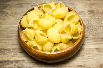 Noodles seashells on wooden background