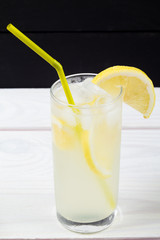 Lemon cocktail with ice and segments of a lemon