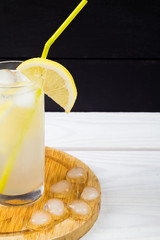 Lemon cocktail with ice and segments of a lemon