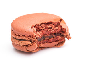 Bite Chocolate macaron on white background.